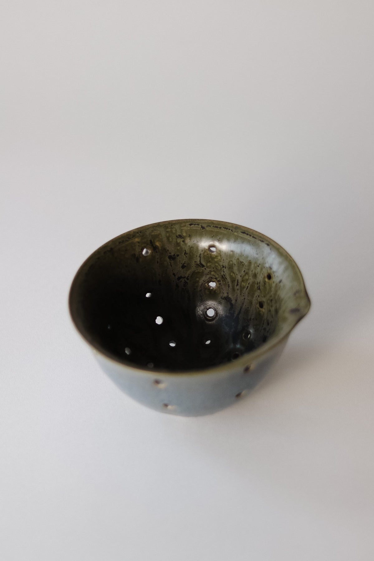 An earthy stoneware berry bowl with a textured exterior and a smooth interior.